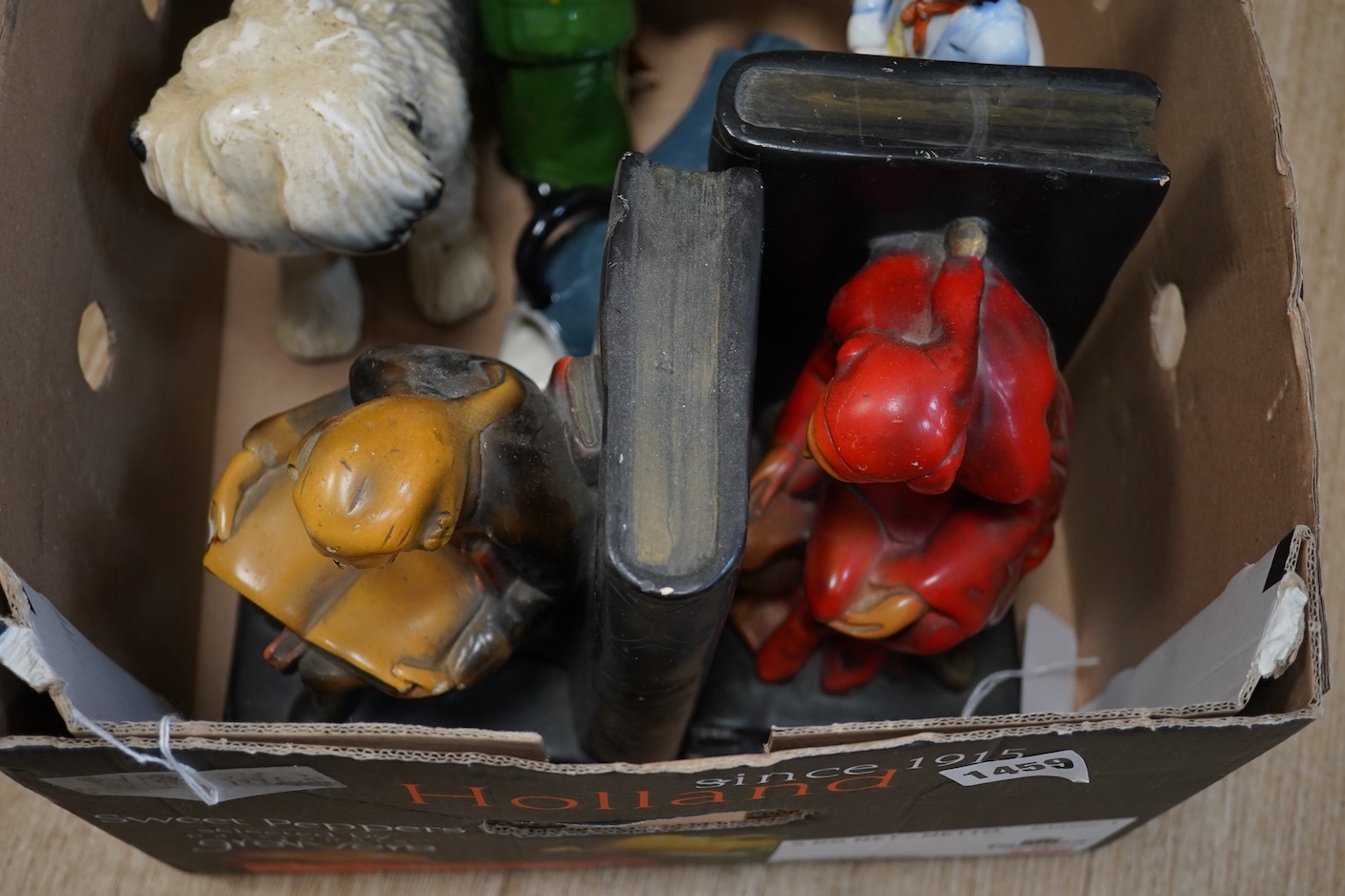 A pair of painted plaster figural bookends, a pottery Highland Cow and other Staffordshire figures etc (7)